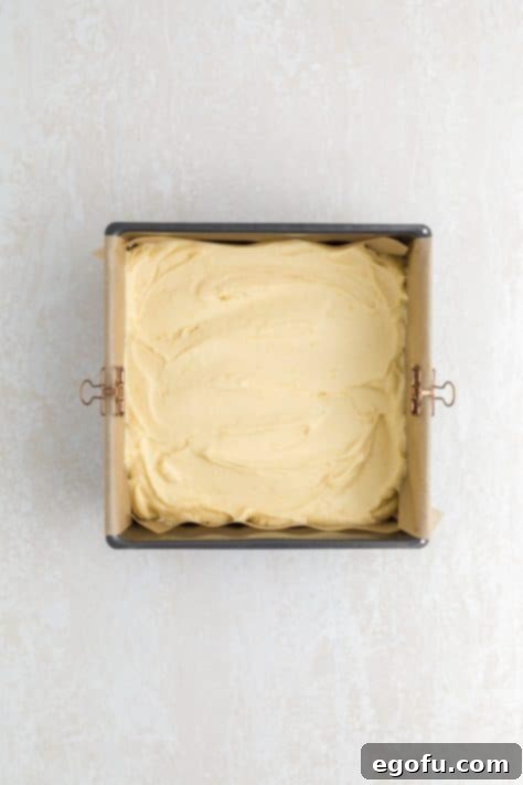 Lemon brownie batter poured into a lined baking tin.