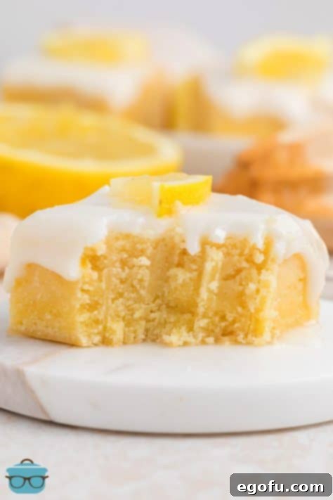 A slice of Homemade Lemon Brownie with a bite missing, showing the set glaze.