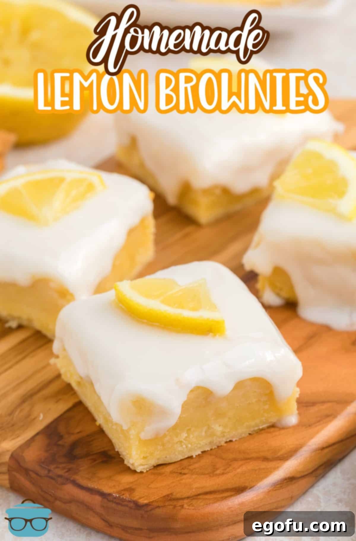 A wooden serving platter with several glazed Homemade Lemon Brownies, artfully arranged and ready for serving.