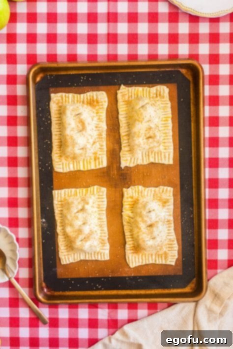 Holes cut on the tops of the unbaked Apple pies.
