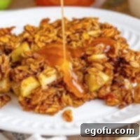 Caramel being drizzled generously over a serving of warm Apple Baked Oatmeal.