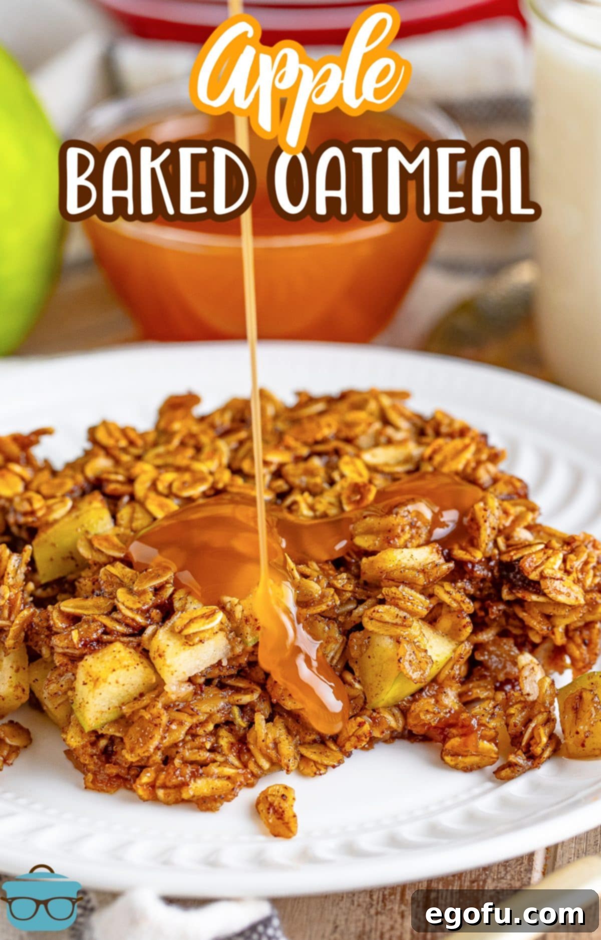 A warm slice of Apple Baked Oatmeal artfully drizzled with sweet caramel sauce on a white plate.