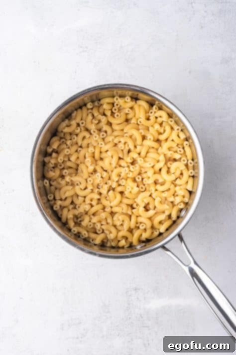 Cheesy Bacon Burger Bake 5 A bowl of perfectly cooked elbow macaroni, drained and rinsed, ready to be added to the rich casserole sauce.