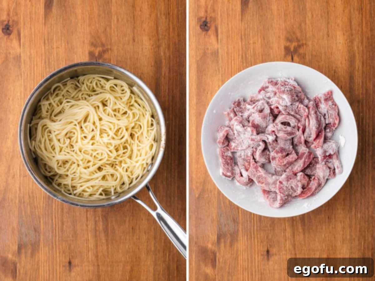 A large skillet containing cooked lo mein noodles and a plate with cornstarch-coated beef slices, ready for the next step.