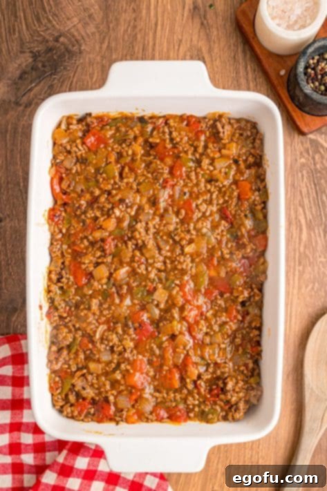 Beef mixture over the biscuit crust.