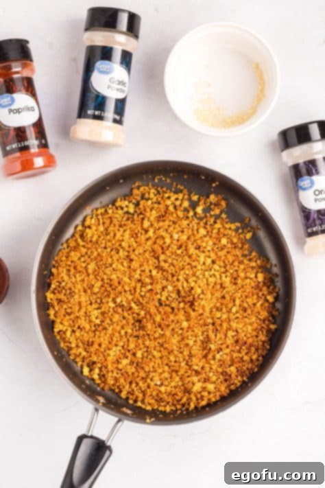 Toasted breadcrumbs with spices in a skillet.