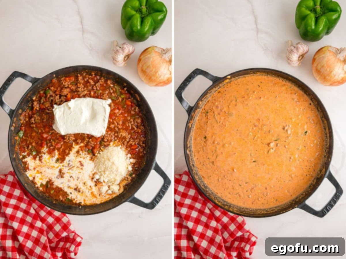 Heavy cream, softened cream cheese, and grated Parmesan cheese being stirred into the tomato-beef mixture in a skillet, creating a luxurious and smooth creamy sauce for the casserole.