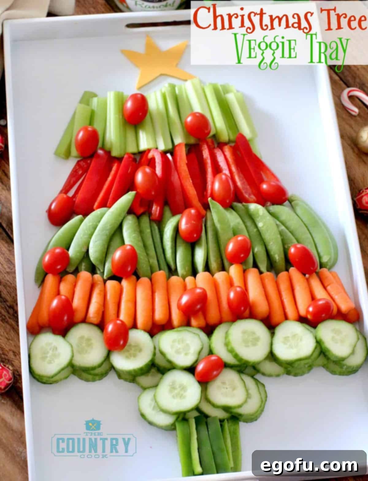 A vegetable tray shaped like a Christmas Tree on a white serving tray.