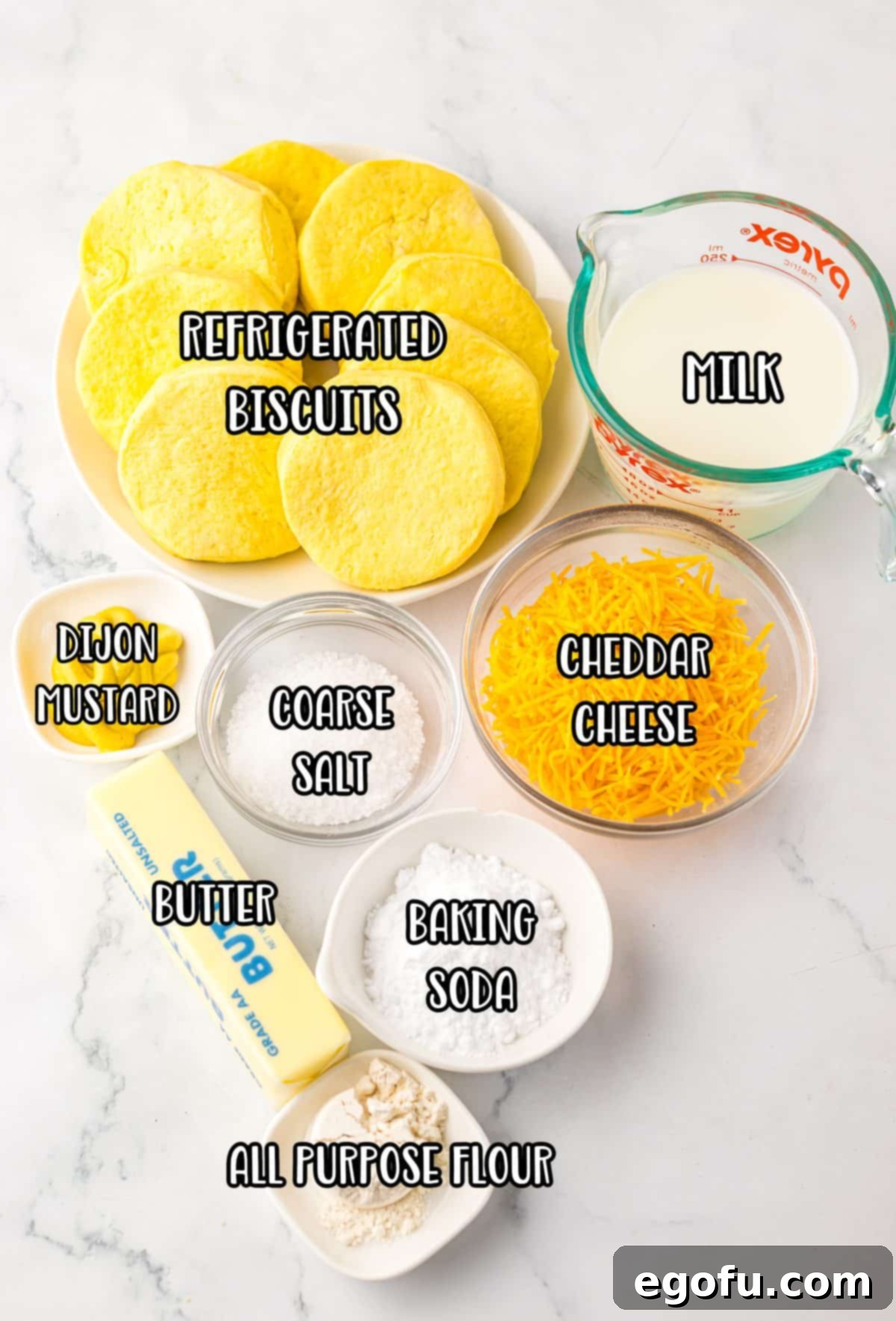 Biscuit dough, milk, cheddar cheese, butter, coarse salt, all purpose flour, dijon mustard, and baking soda. 