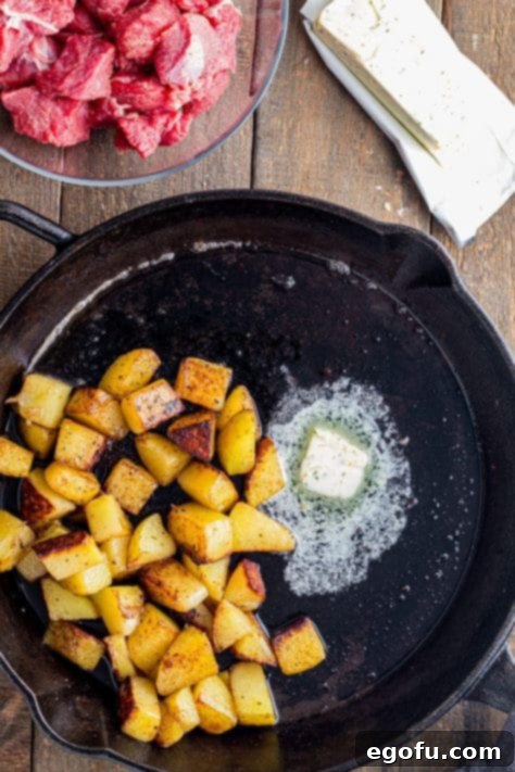 Pan-Seared Garlic Butter Steak Bites with Crispy Potatoes 8 Cooked steak and potatoes coated in melted garlic butter, tossed together in the skillet.