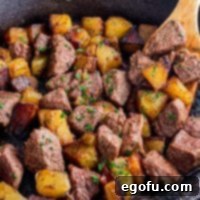 Pan-Seared Garlic Butter Steak Bites with Crispy Potatoes 10 A close-up view of a skillet filled with perfectly cooked Garlic Butter Steak Bites and Potatoes.