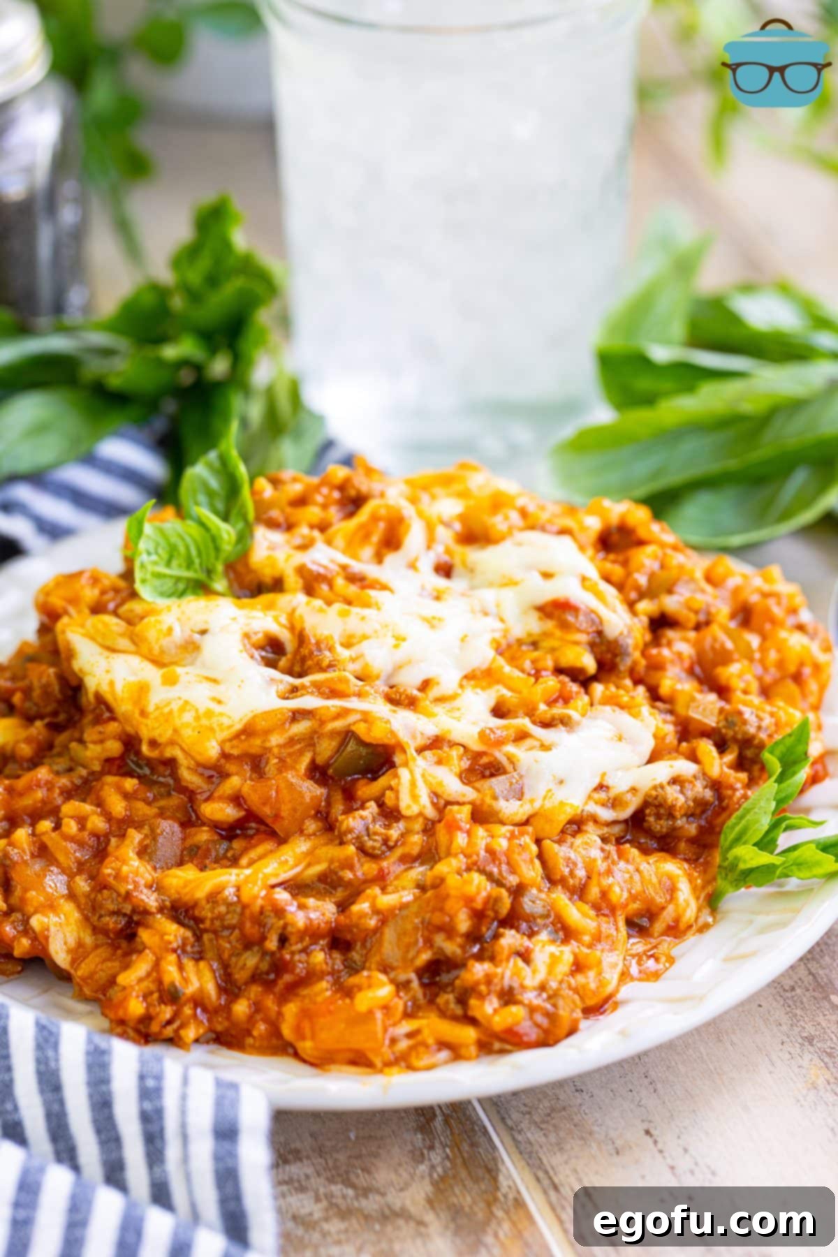 An overflowing plate of Italian Rice Casserole, showcasing its rich texture and cheesy top.