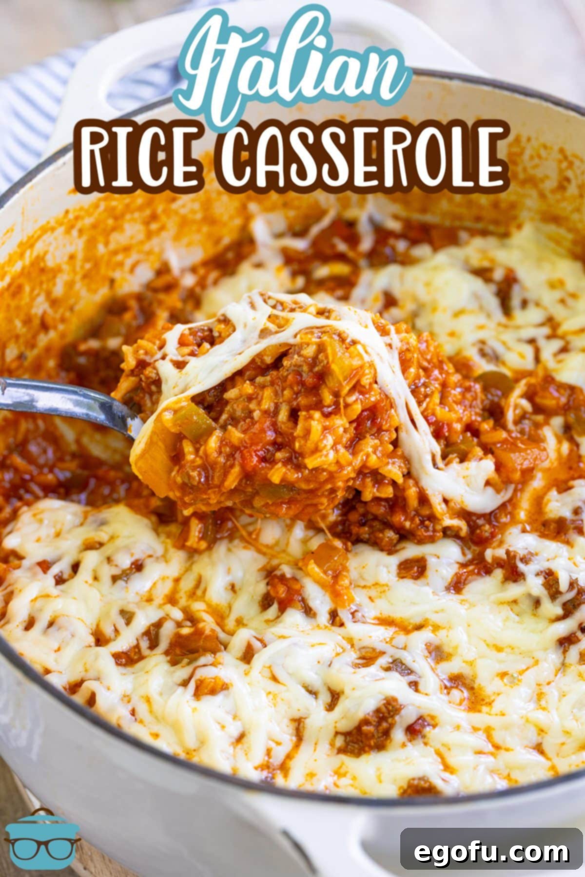 A serving spoon getting a scoop of savory Italian Rice Casserole from a big pot, highlighting the gooey cheese.