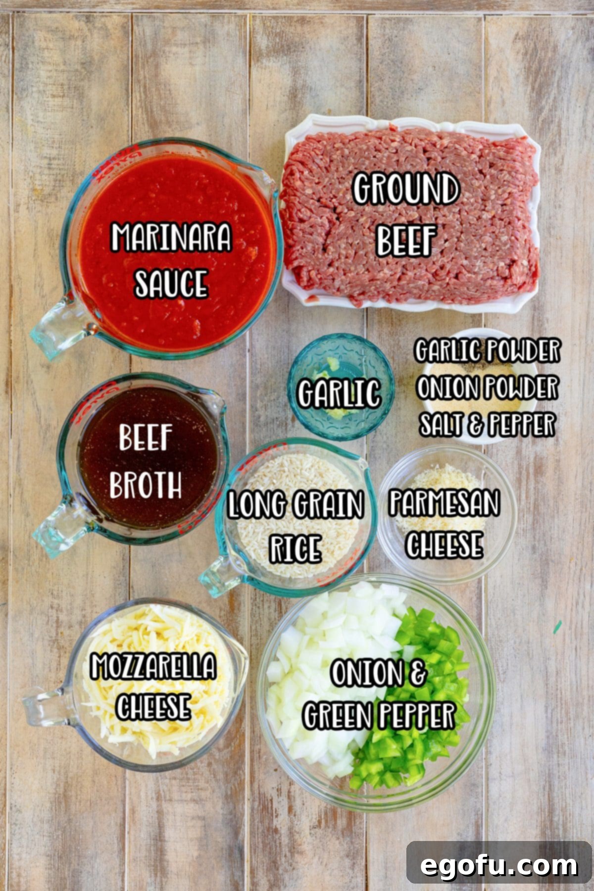 A vibrant display of fresh marinara sauce, ground beef, beef broth, garlic, garlic powder, onion powder, salt, pepper, parmesan cheese, long grain rice, mozzarella cheese, onions, and green peppers, ready for the Italian Rice Casserole.