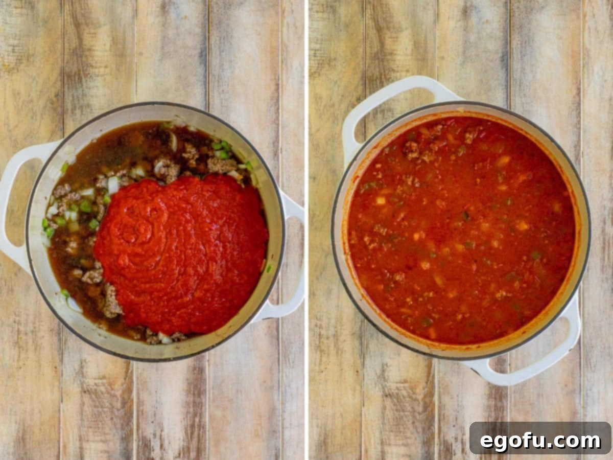 Rich beef broth and a generous jar of marinara sauce being stirred into the savory beef and vegetable mixture in a deep skillet, creating the flavorful base for the Italian Rice Casserole.