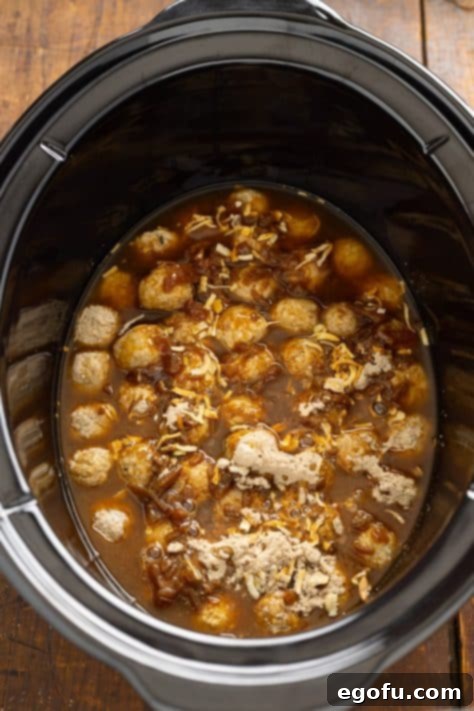 Onion soup mix and beef broth poured on top of meatballs in slow cooker.