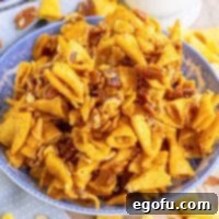 Closely looking down on a bowl of Sweet Bugle Party Mix, highlighting its golden appeal.