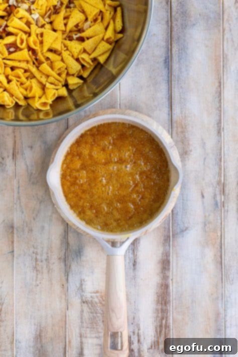 The buttery brown sugar and corn syrup mixture simmering gently in a pot on the stovetop.