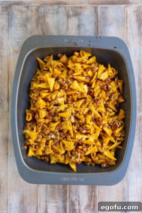 Bugle Sweet Party Mix baking in a roasting dish, getting beautifully caramelized.