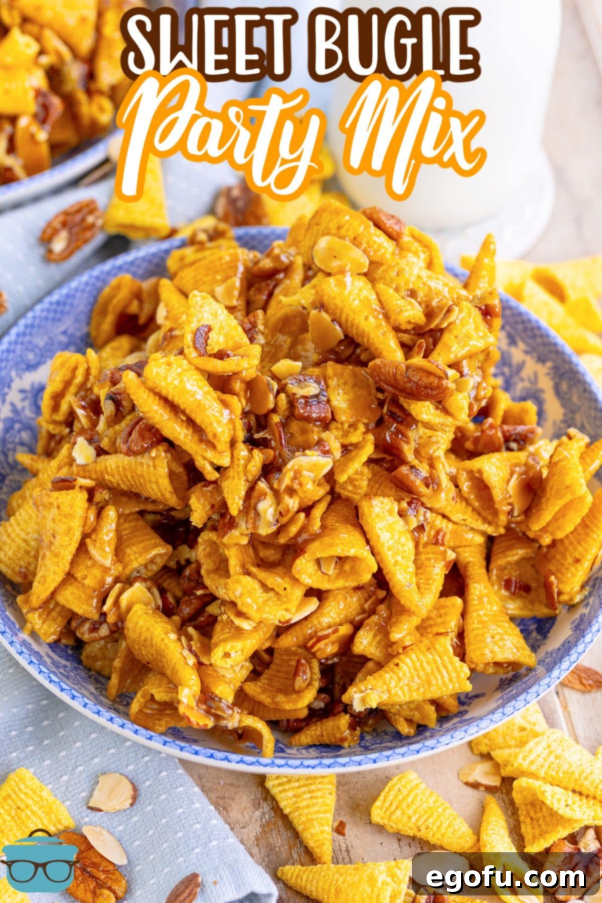 A vibrant blue bowl filled to the brim with Sweet Bugle Party Mix.