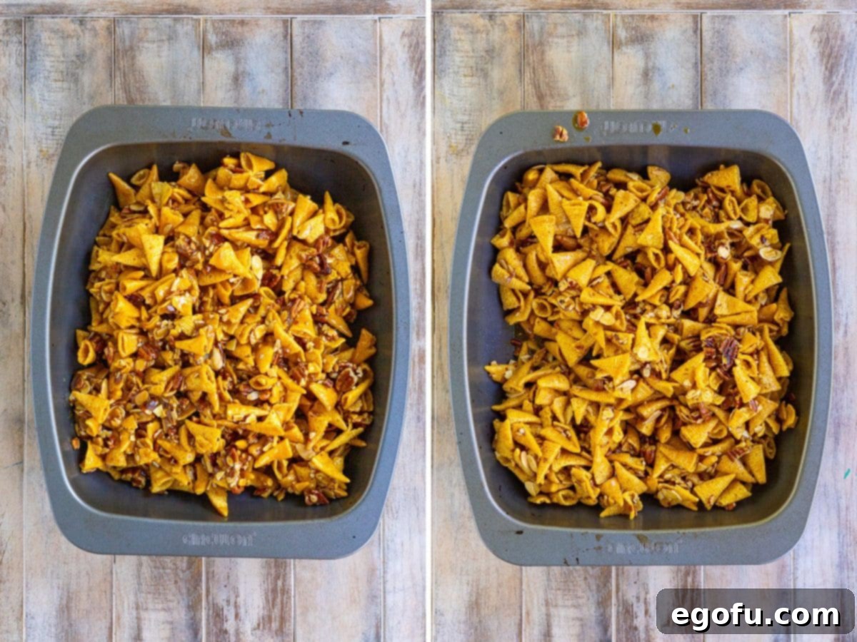 The party mix evenly spread in a baking dish, perfectly caramelizing in the oven.