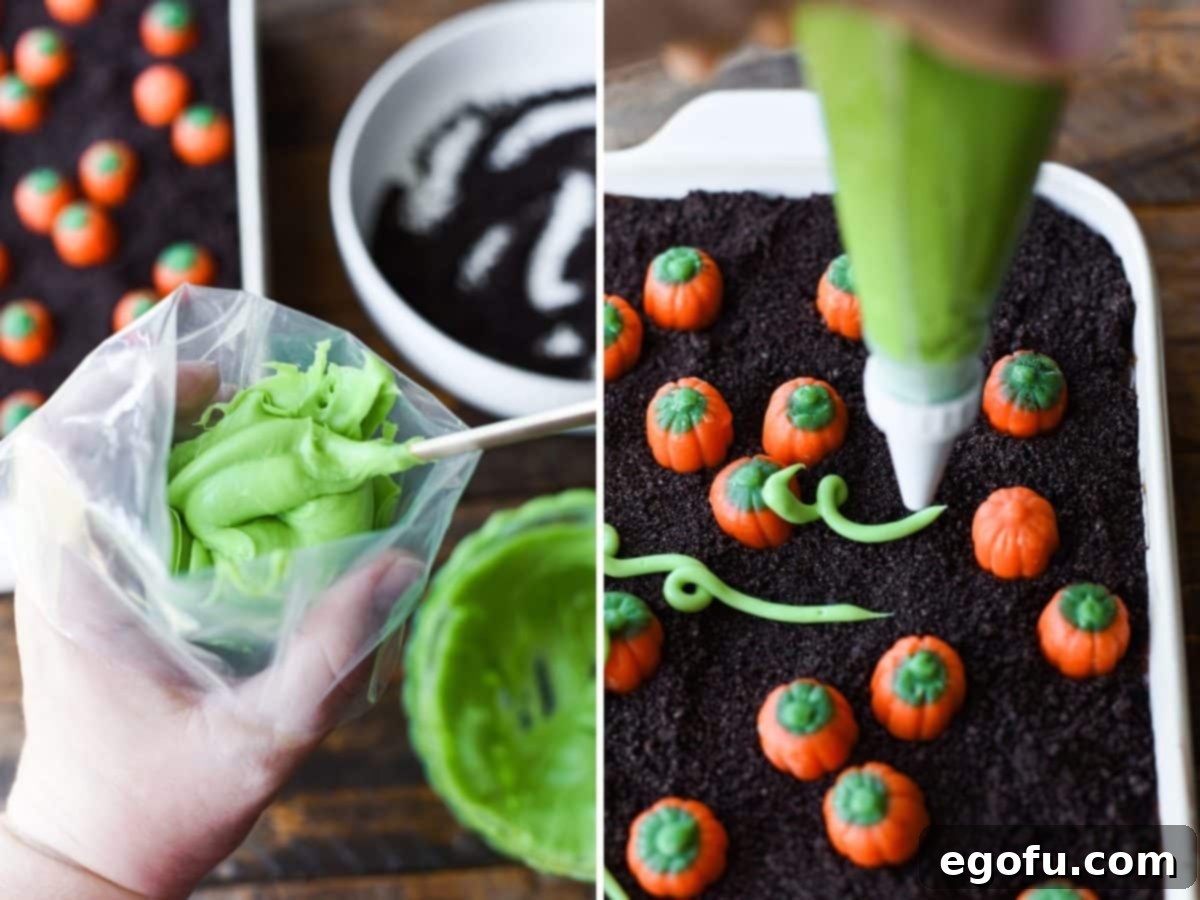 Green frosting being piped from a bag to create vines around the pumpkin candies.