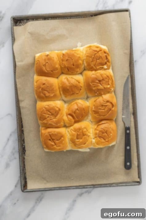 Irresistible King's Hawaiian Cinnamon Buns 10 King's Hawaiian Rolls on parchment paper.