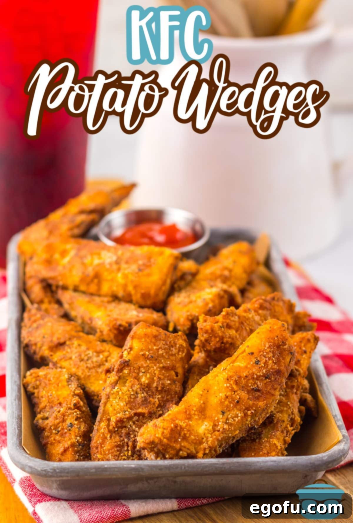 A tray of KFC Potato Wedges on a picnic table cloth.