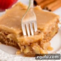 A fork in a slice of Apple Dapple Cake.