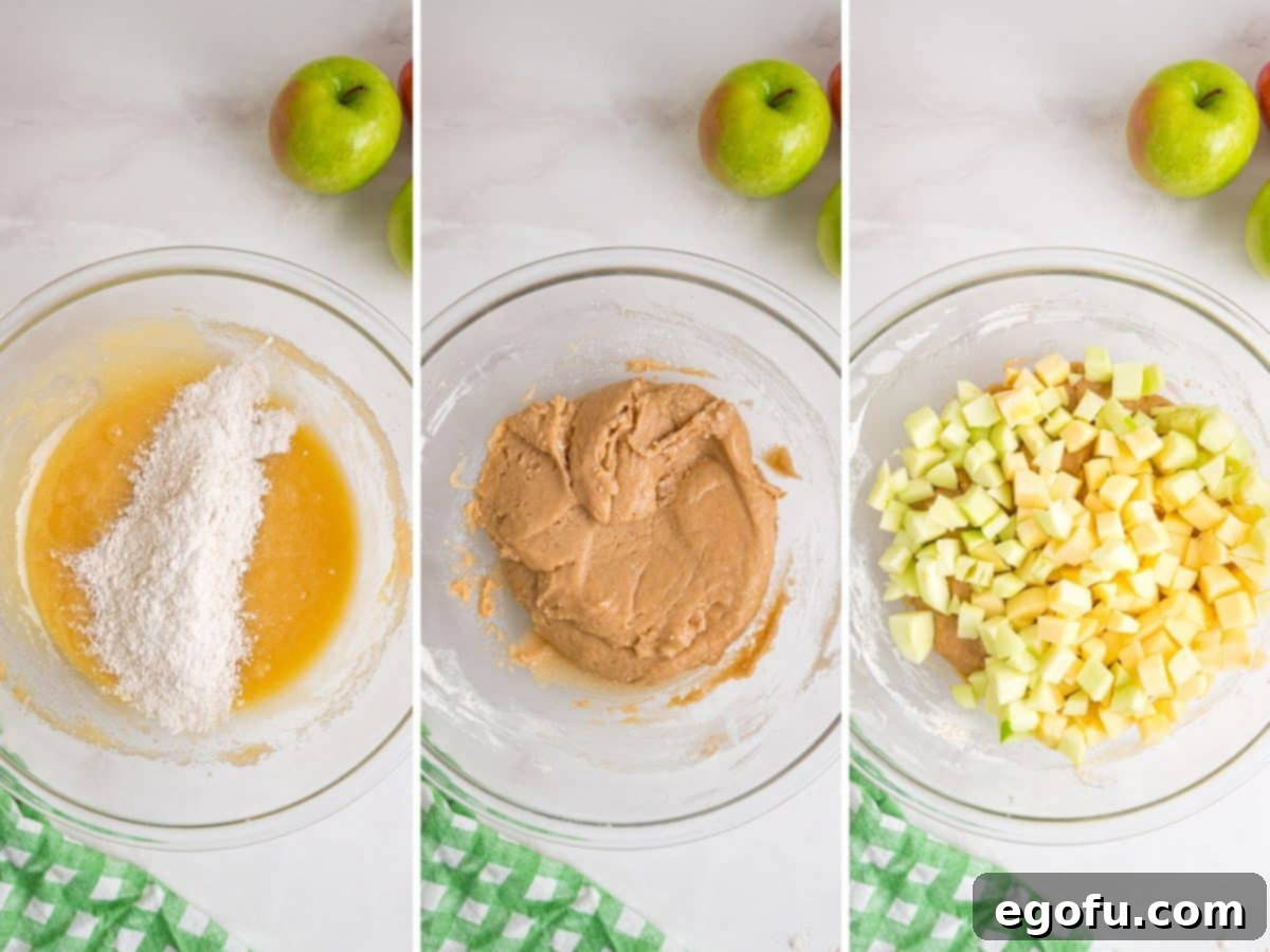 Dry ingredients being folded into wet ingredients to create a cake batter, followed by diced apples being gently incorporated.