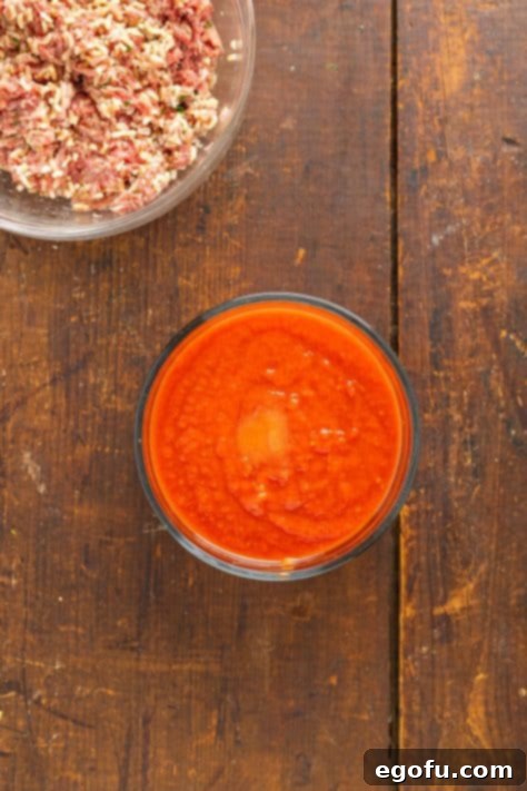 Effortless Crock Pot Cabbage Rolls 12 A bowl of tomato soup, crushed tomatoes and sugar.