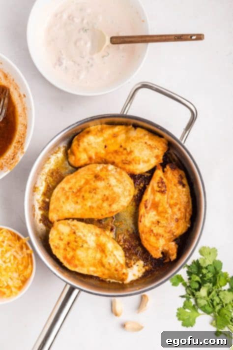 Zesty Fiesta Lime Chicken 9 Chicken cooking in a skillet with marinade.