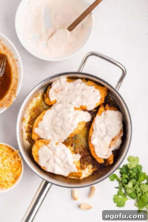 Zesty Fiesta Lime Chicken 10 Sauce on top of cooking chicken in a skillet.