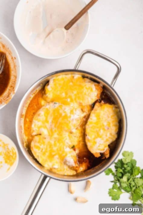 Zesty Fiesta Lime Chicken 12 Melted cheese on chicken in a skillet.