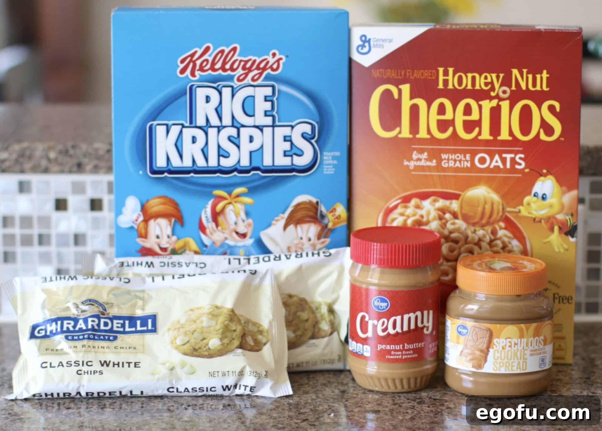 Individual ingredients for No Bake Avalanche Cookies laid out: Rice Krispies, Honey Nut Cheerios, white chocolate chips, creamy peanut butter, and cookie butter, ready for preparation.