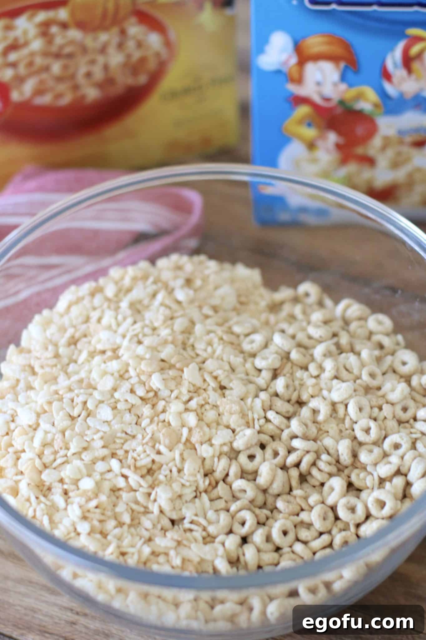 Rice Krispies and honey nut cheerios mixed together in a bowl, showing the crisp and airy texture of the cereal blend.