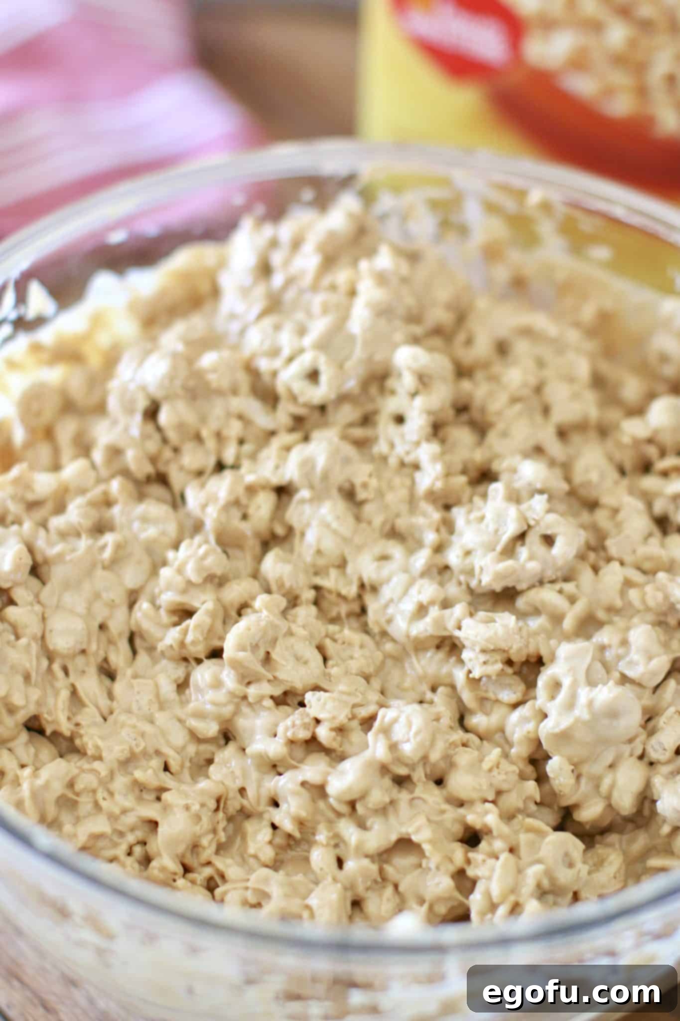 No bake avalanche cookies batter in a clear large bowl, showing all ingredients thoroughly combined and coated.