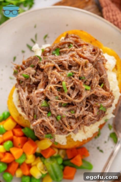 Looking down on an open faced Beef Manhattan with vegetables.