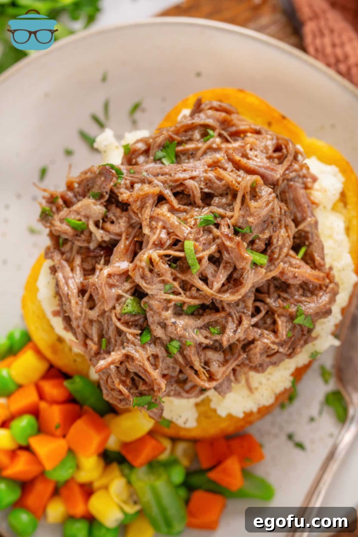 Looking down on an open faced Beef Manhattan with vegetables.