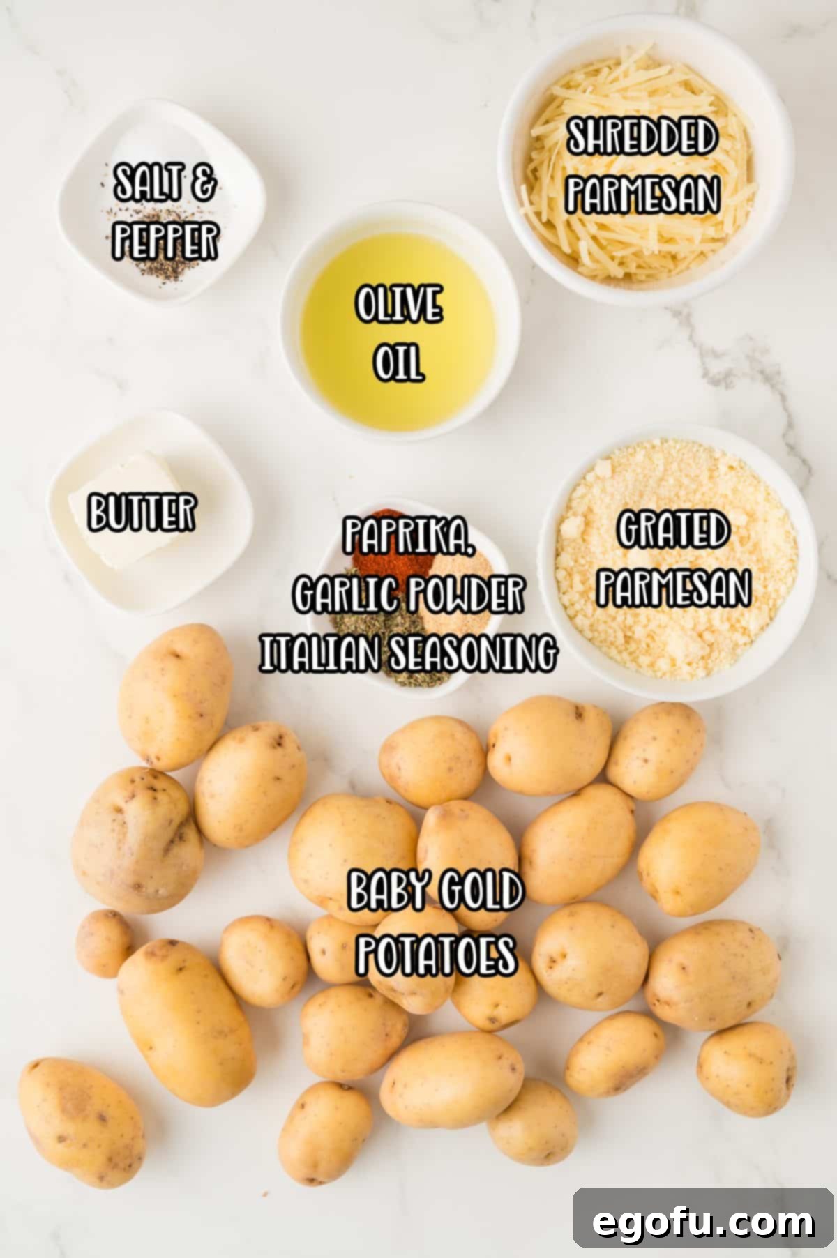 Baby gold potatoes, grated parm, olive oil butter, salt, pepper, shredded parmesan cheese, paprika, garlic powder, and Italian seasoning laid out.