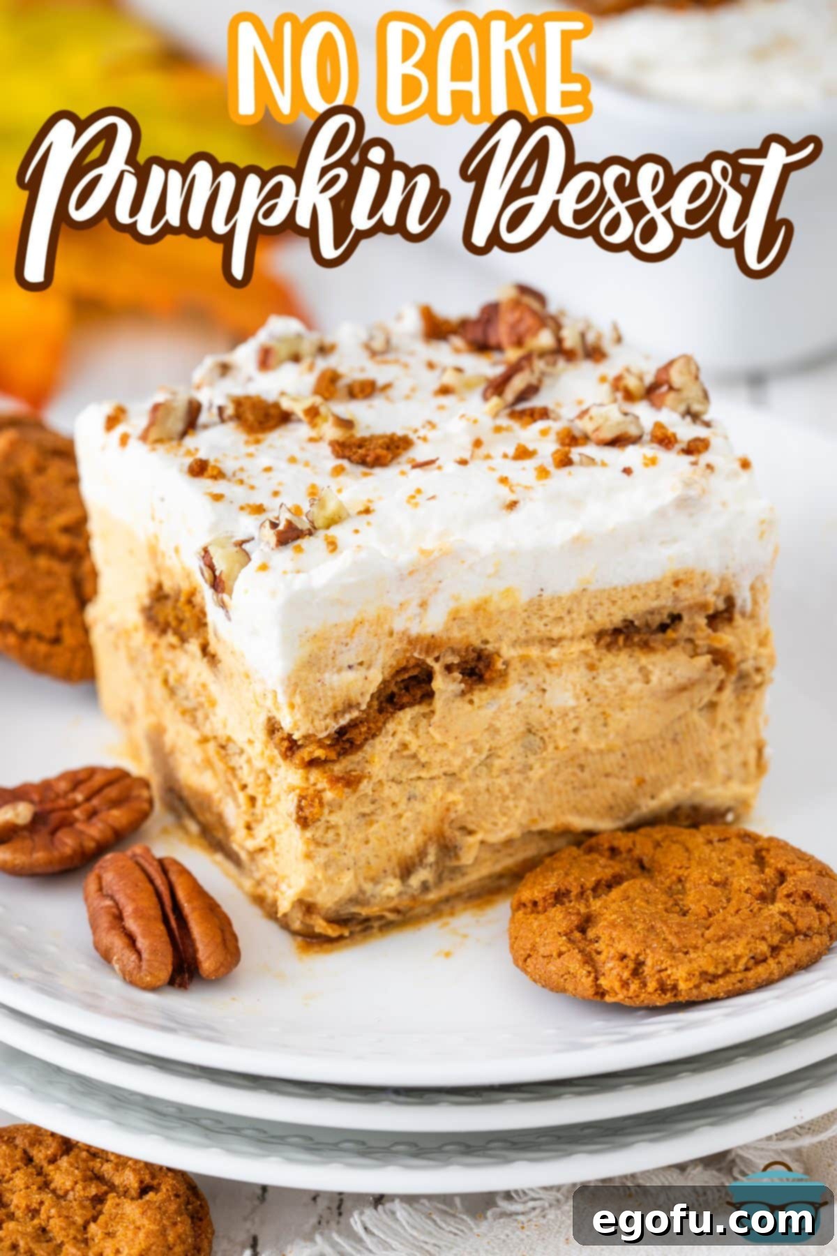 A full slice of No Bake Pumpkin Dessert on a stack of white plates, showing distinct layers.