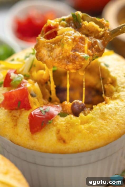 Golden Cornbread Chili Bake 13 A spoon taking a bite of Cornbread Chili Pot Pie.