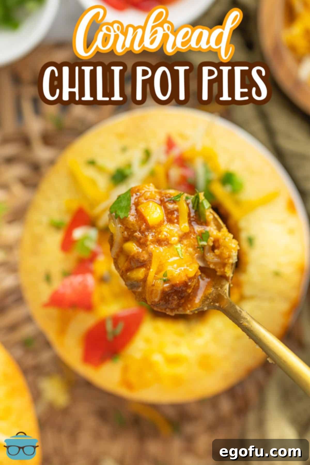 Golden Cornbread Chili Bake 3 A spoon holding a bite of Cornbread Chili Pot Pie above the pot pie.