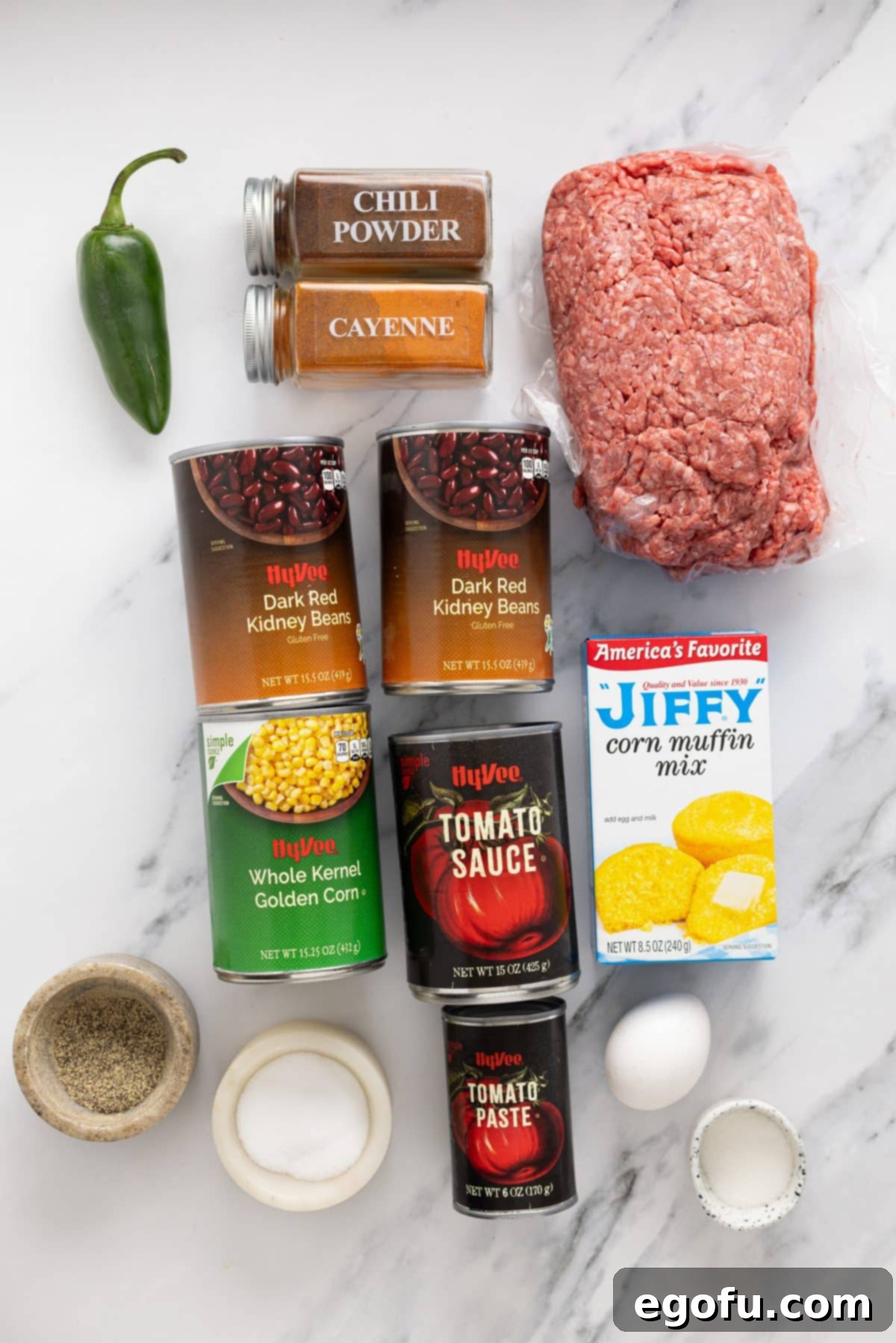 Golden Cornbread Chili Bake 4 Ground beef, kidney beans, corn, tomato sauce, tomato paste, water, jalapenos, cayenne pepper, chili powder, salt, pepper, sugar, cornbread mix, eggs, and milk.