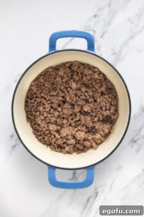 Golden Cornbread Chili Bake 8 Ground beef in a dutch oven.