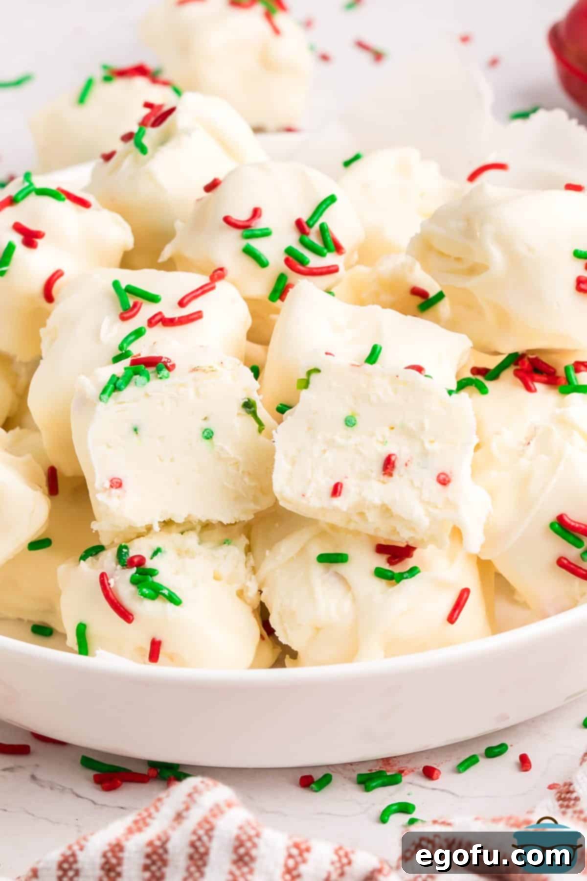 Creamy Cloud Bites 2 A white serving bowl of Cool Whip Candy, garnished with festive sprinkles, hinting at its deliciousness and ease of preparation.