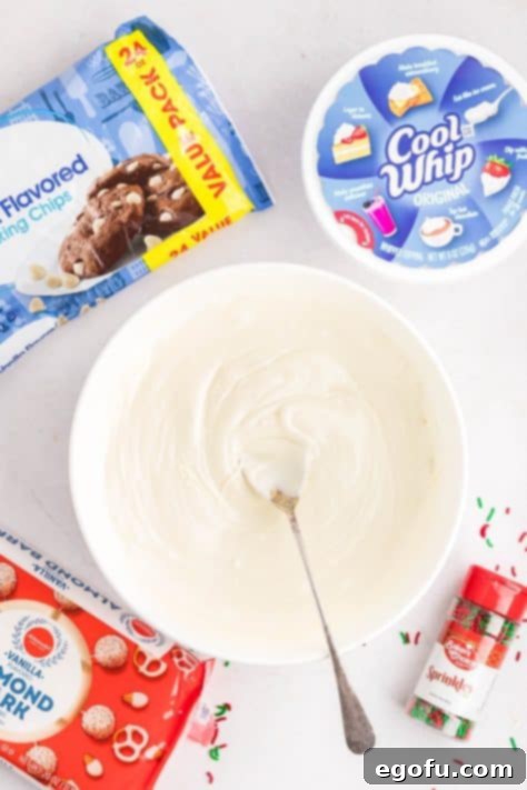 Creamy Cloud Bites 11 Melted white chocolate chips in a bowl, ready for mixing.