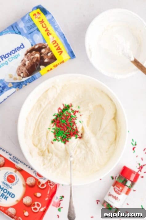 Creamy Cloud Bites 13 Sprinkles being added to a mixture of melted chocolate and Cool Whip, preparing for the next step.