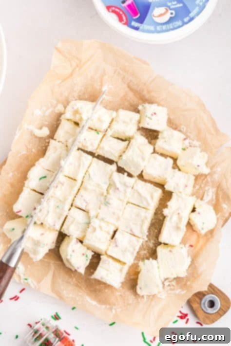 Creamy Cloud Bites 15 Candy being cut into pieces on a cutting board, ready for the next stage of preparation.