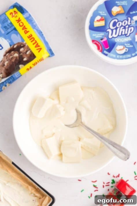 Creamy Cloud Bites 16 Almond bark being melted in a bowl and stirred, showing its transition to a smooth, liquid state.